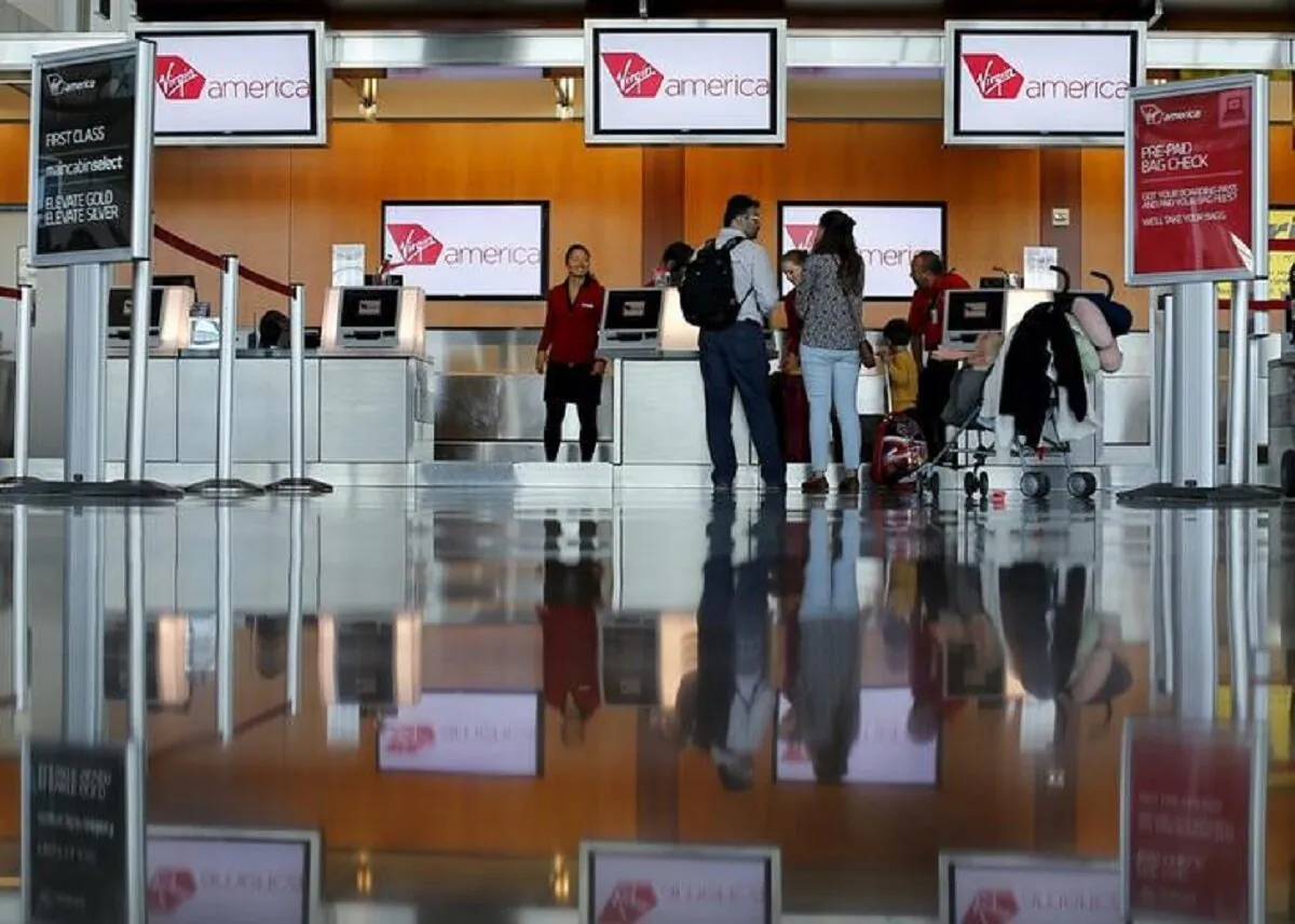 Passengers check in for their flights at the Virgin America ticket counter in San Diego on April 4, 2016. (Mike Blake/Reuters)