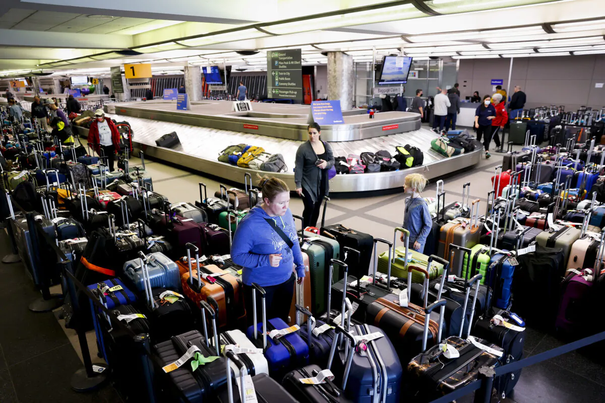 Travelers search for their suitcases in a baggage holding area for Southwest Airlines at Denver International Airport, in Denver, on Dec. 28, 2022. At the time, just before holiday travel, more than 15,000 flights were canceled by airlines when winter weather impacted air travel. (Michael Ciaglo/Getty Images)