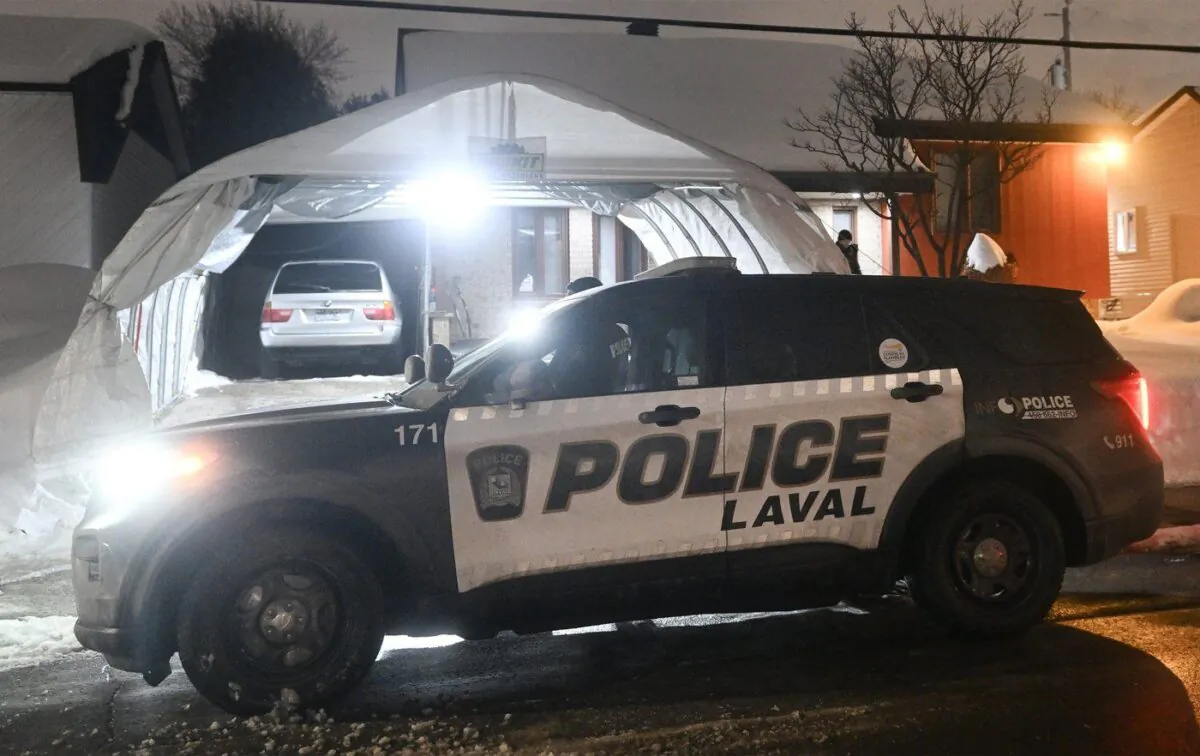 Police are shown outside the home of Pierre Ny St-Amand in Laval, Que, Feb. 8, 2023. (The Canadian Press/Graham Hughes)