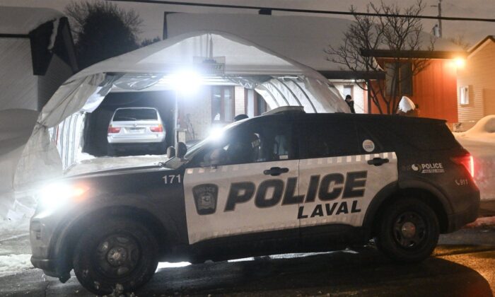 Police are shown outside the home of Pierre-ny-St.  (The Canadian Press/Graham Hughes)