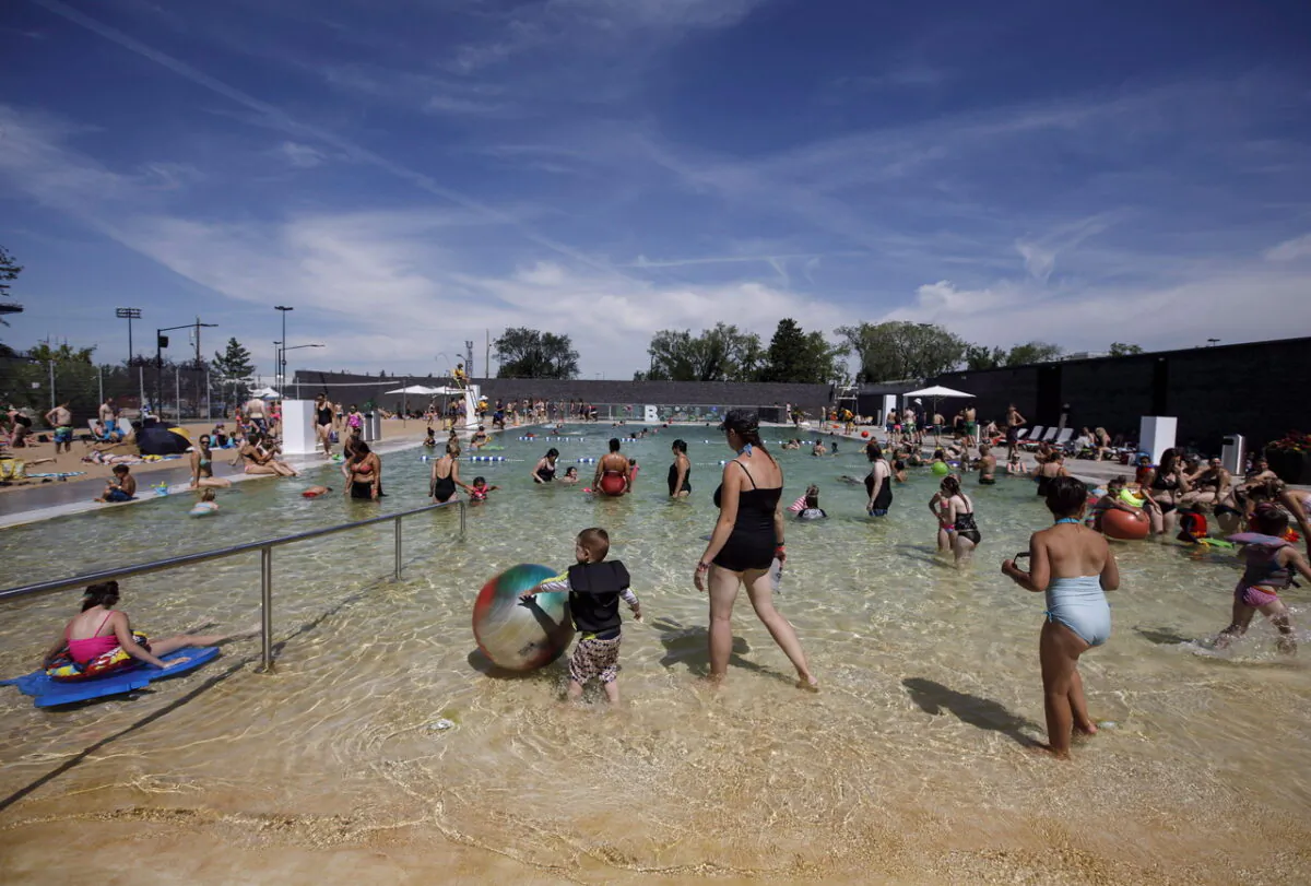 Members of the public enjoy a sunny day at an outdoor pool in Edmonton on July 16, 2018. (Jason Franson/The Canadian Press)