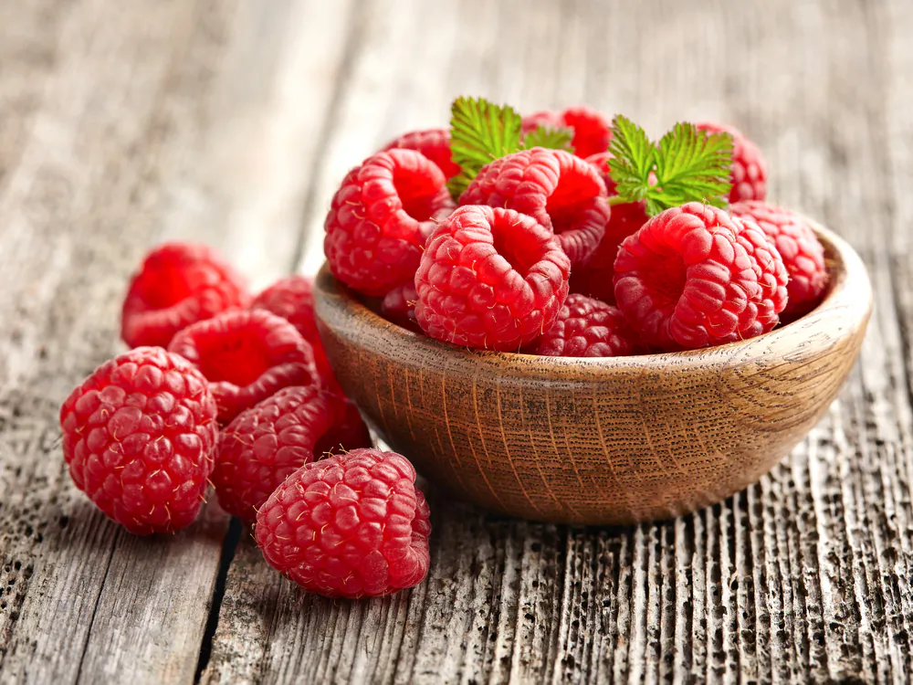 Fresh raspberries are added for a pop of tart brightness to balance the sweetness of the cake. (Dionisvera/Shutterstock)