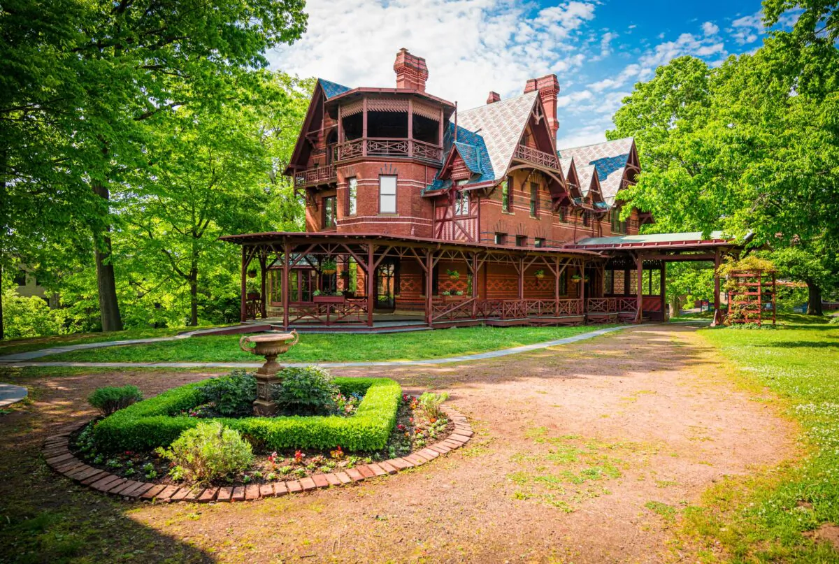 The Mark Twain House’s main exterior architectural design feature, according to Society of Architectural Historians, is the extensive wood bracing of the gables, porch, and railings in what was known as “stick style.” Approaching the front of the home, visitors are struck by the conspicuous octagonal tower and the large wraparound porch. Red brick masonry is set off with a patterned, tricolor slate tile roof and four polychrome-brickwork chimneystacks. (Courtesy of the Mark Twain House)