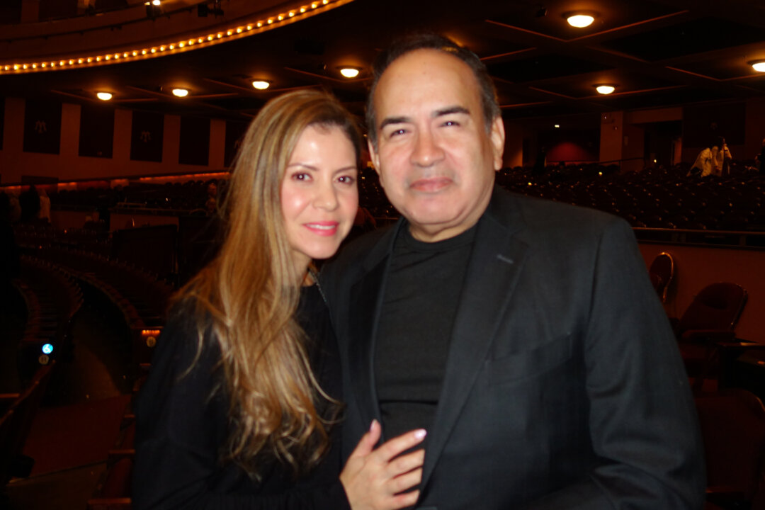 President and CEO of the Hispanic Chamber of Commerce of Wisconsin, Jorge Franco (R) with his wife Miriam Franco (L) watch Shen Yun Performing Arts at the Milwaukee’s Miller High Life Theater, on Feb. 17, 2023. (Michael Huang/The Epoch Times)
