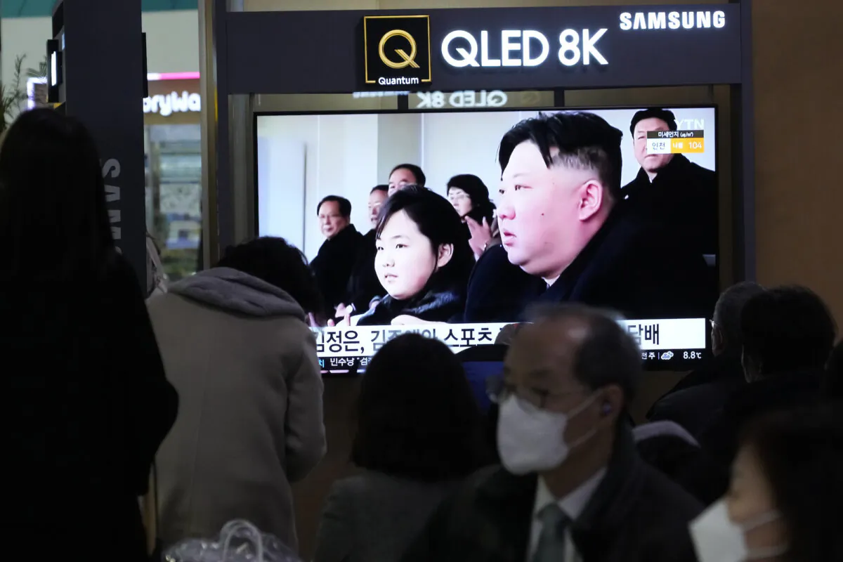 A TV screen shows a file image of North Korean leader Kim Jong Un (R) and his daughter, reportedly named Kim Ju Ae, during a news program at the Seoul Railway Station in Seoul, South Korea, on Feb. 18. 2023. (AP Photo/Ahn Young-joon)