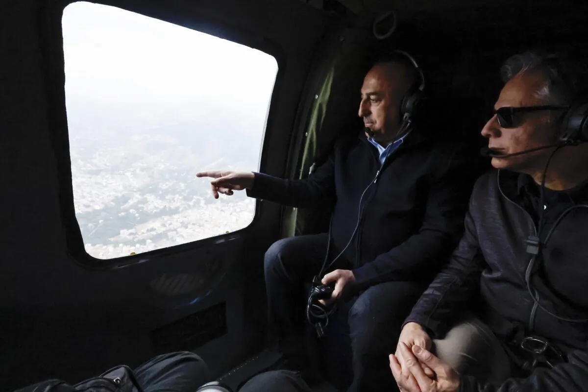 U.S. Secretary of State Antony Blinken (R) and Turkish Foreign Minister Mevlut Cavusoglu sit in a helicopter for a tour of earthquake stricken areas in Turkey on Feb. 19, 2023. (Clodagh Kilcoyne/Pool Photo via AP)