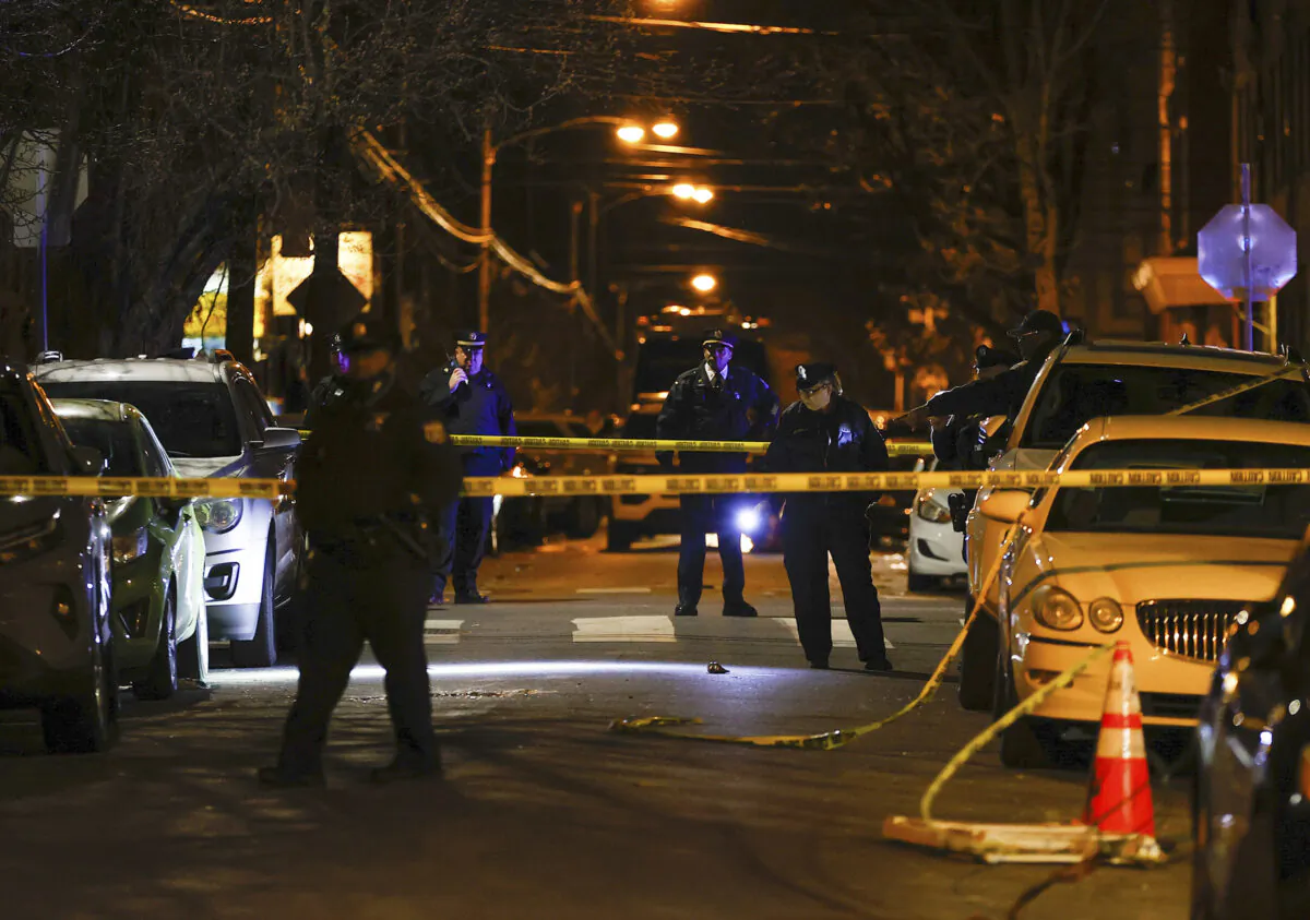 Philadelphia police officers investigate the fatal shooting of a Temple University police officer near the campus in Philadelphia on Feb. 18, 2023. (Yong Kim/The Philadelphia Inquirer via AP)