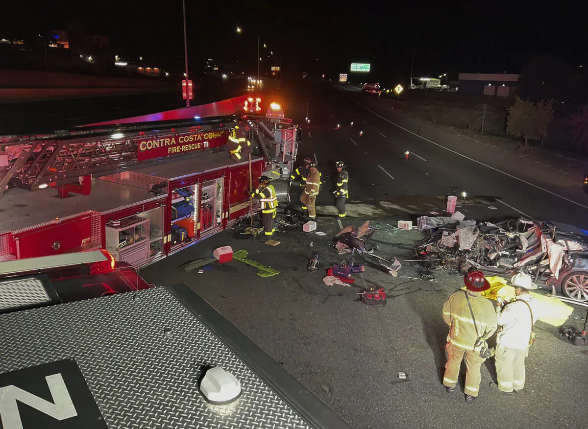 Firefighters work the scene of a fatal accident involving a Tesla and Contra Costa County fire truck in Contra Costa, Calif., on Feb. 18, 2023. (Contra Costa County Fire Protection District via AP)