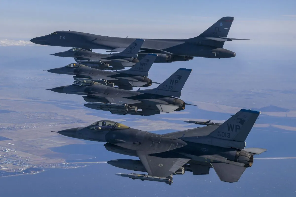 A U.S. Air Force B-1B bomber (top) flies in formation with U.S. Air Force F-16 fighter jets over the South Korea Peninsula during a joint air drill in South Korea on Feb. 19, 2023. (South Korea Defense Ministry via AP)