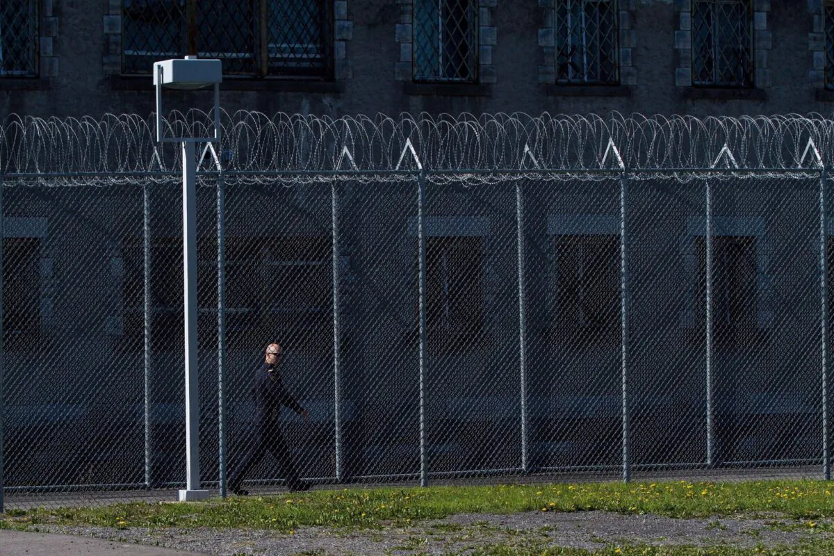A correctional officer walks inside the Collins Bay Institution in Kingston, Ont., on May 10, 2016. (The Canadian Press/Lars Hagberg)