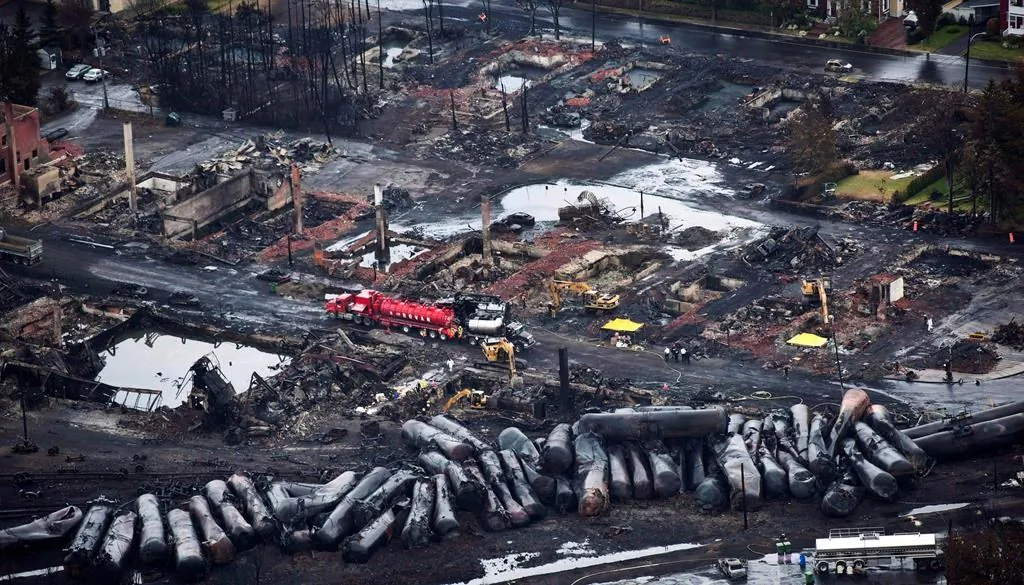 Workers comb through debris after a train derailed in Lac-Megantic, Que., on July 9, 2013. (The Canadian Press/Paul Chiasson)