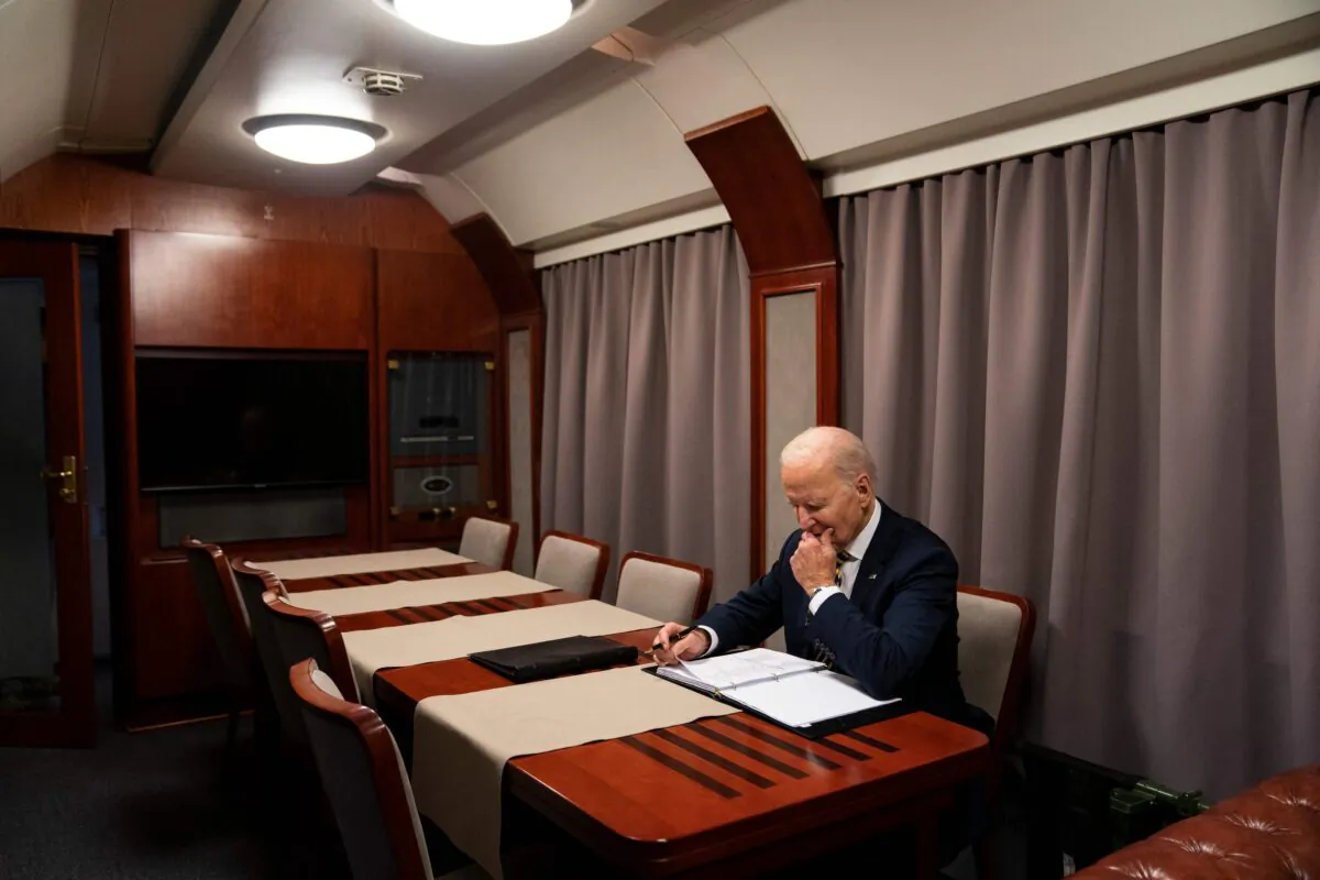 President Joe Biden sits on a train as he goes over his speech marking the one-year anniversary of the war in Ukraine after a surprise visit to meet with Ukrainian President Volodymyr Zelenskyy, in Kyiv on Feb. 20, 2023. (Evan Vucci/AFP via Getty Images)