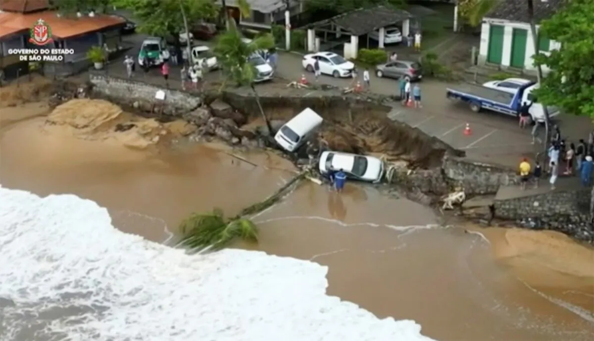 Vehicles fallen from an elevated area along the beach in Sao Sebastiao, east of Sao Paulo, Brazil, on Feb. 19, 2023. (Sao Paulo Government via AP)