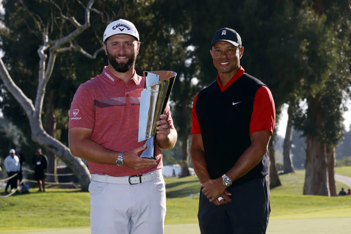 Jon Rahm (L) holds the winner's trophy next to Tiger Woods after winning the Genesis Invitational golf tournament at Riviera Country Club in the Pacific Palisades area of Los Angeles on Feb. 19, 2023. (Ryan Kang/AP Photo)