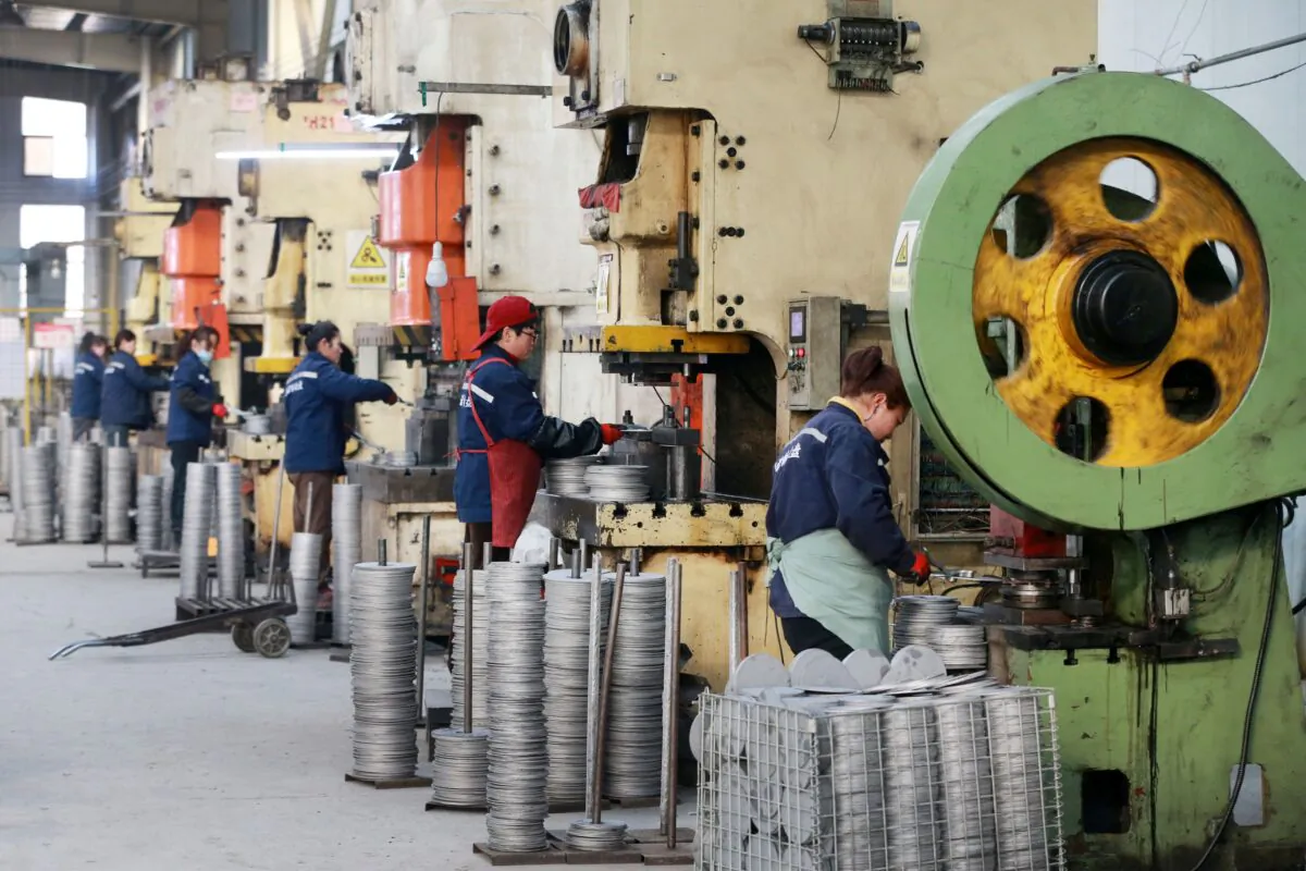 Employees working on aluminum products at a factory in Huaibei, Anhui Province, China, on Jan. 31, 2023. (STR/AFP via Getty Images)