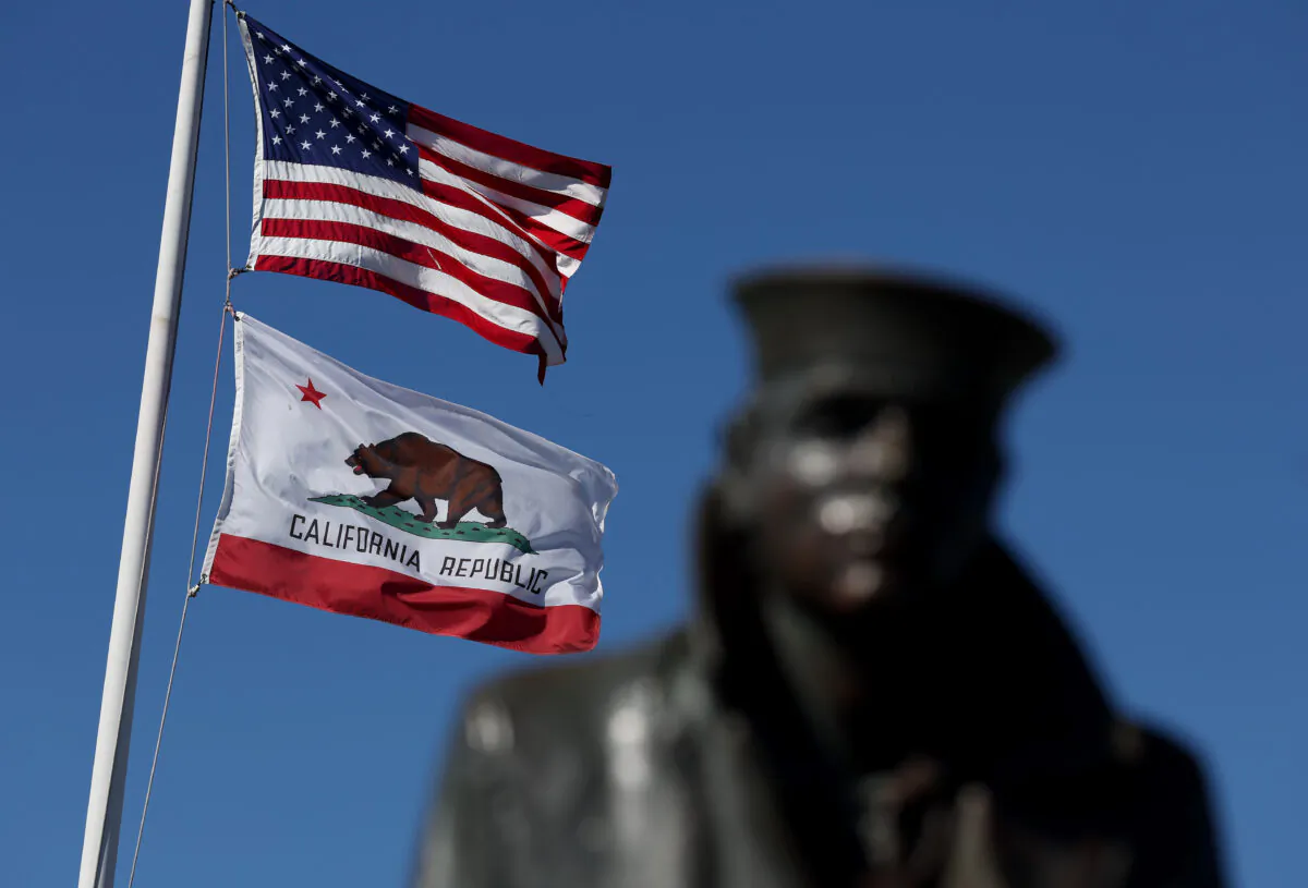 An American flag flies with the California State flag next to the Lone Sailor statue in Sausalito, California, on Oct. 24, 2022. (Justin Sullivan/Getty Images)