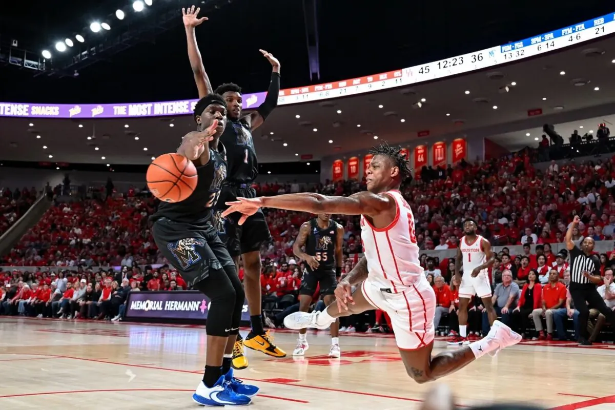 Houston Cougars guard Marcus Sasser (0) passes the ball around Memphis Tigers forward Malcolm Dandridge (23) during the second half at Fertitta Center in Houston on Feb. 19, 2023. (Maria Lysaker-USA TODAY Sports via Field Level Media)