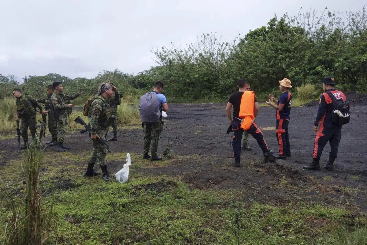 Rescuers prepare to search for passengers of a Cessna 340 aircraft with registry number RP-C2080 at Tumpa Gulley, Camalig town, Albay province, the Philippines, on Feb. 20, 2023. (Bureau of Fire Protection Camalig via AP)