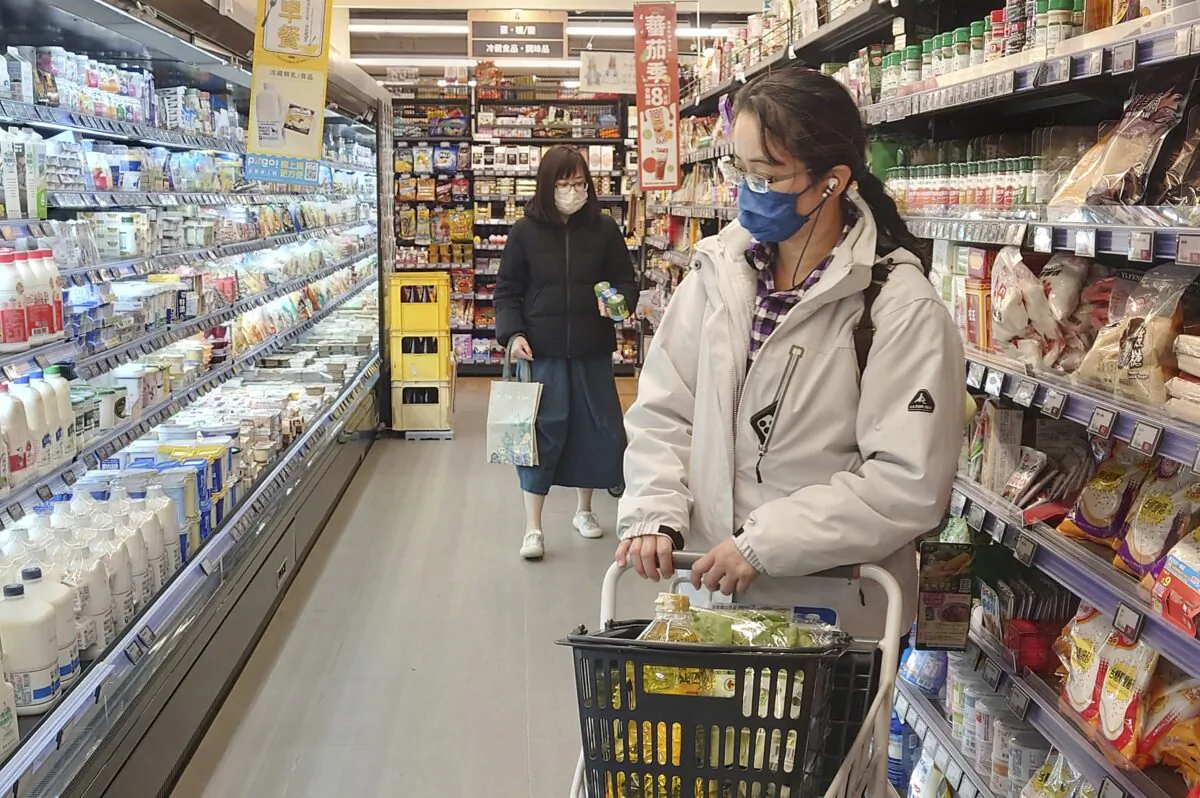 People wear masks as they shop at a supermarket in Taipei, Taiwan, on Feb. 20, 2023. (Chiang Ying-ying/AP Photo)