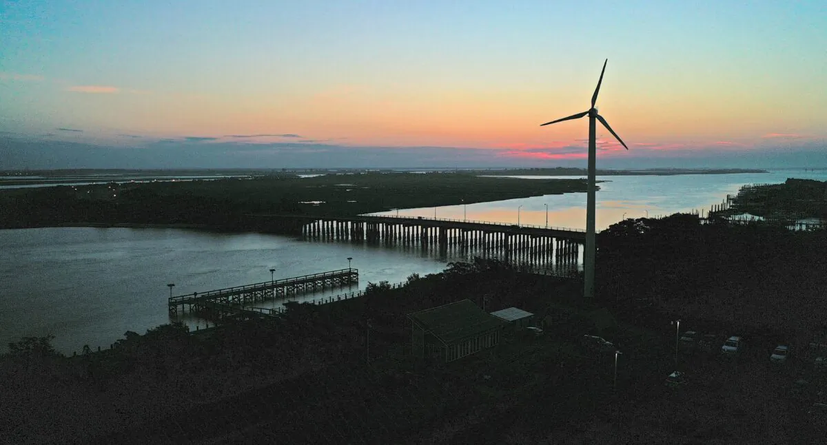 A wind turbine spins at sunrise in Lido Beach, N.Y., on July 20, 2022. (Bruce Bennett/Getty Images)