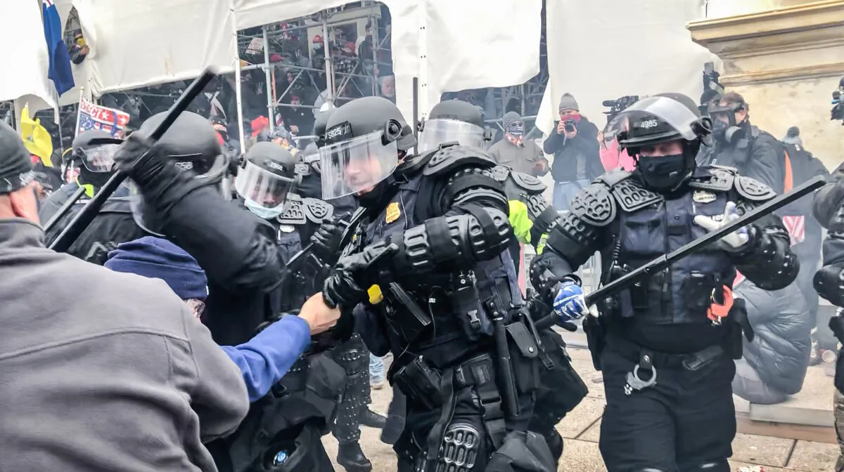 D.C. Metropolitan Police Department riot officers clash with protesters on the west front of the U.S. Capitol on Jan. 6, 2021. (Steve Baker/Special to The Epoch Times)