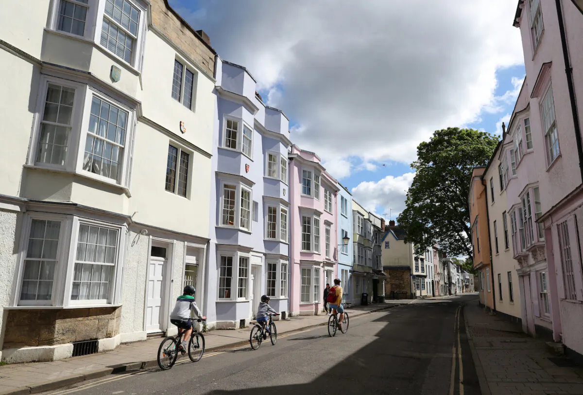 People cycle along an empty street in Oxford, England, on May 2, 2020.(Catherine Ivill/Getty Images)