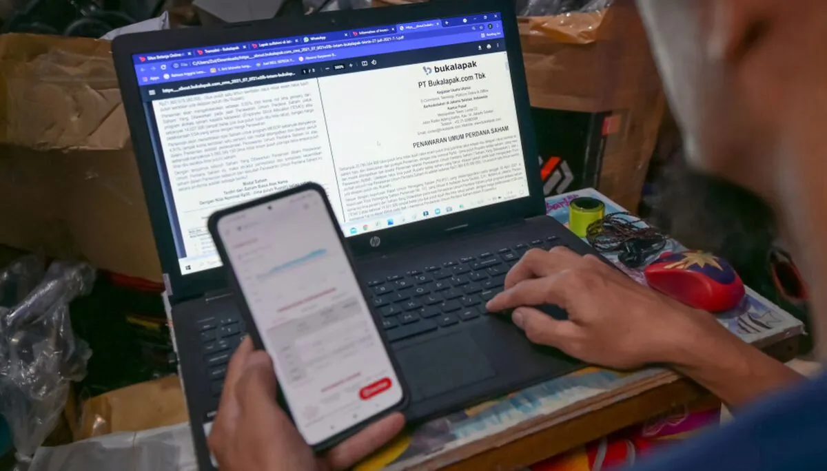 A file photo shows a man using a laptop with the Microsoft Windows operating system. (Bay Ismoyo/AFP via Getty Images)