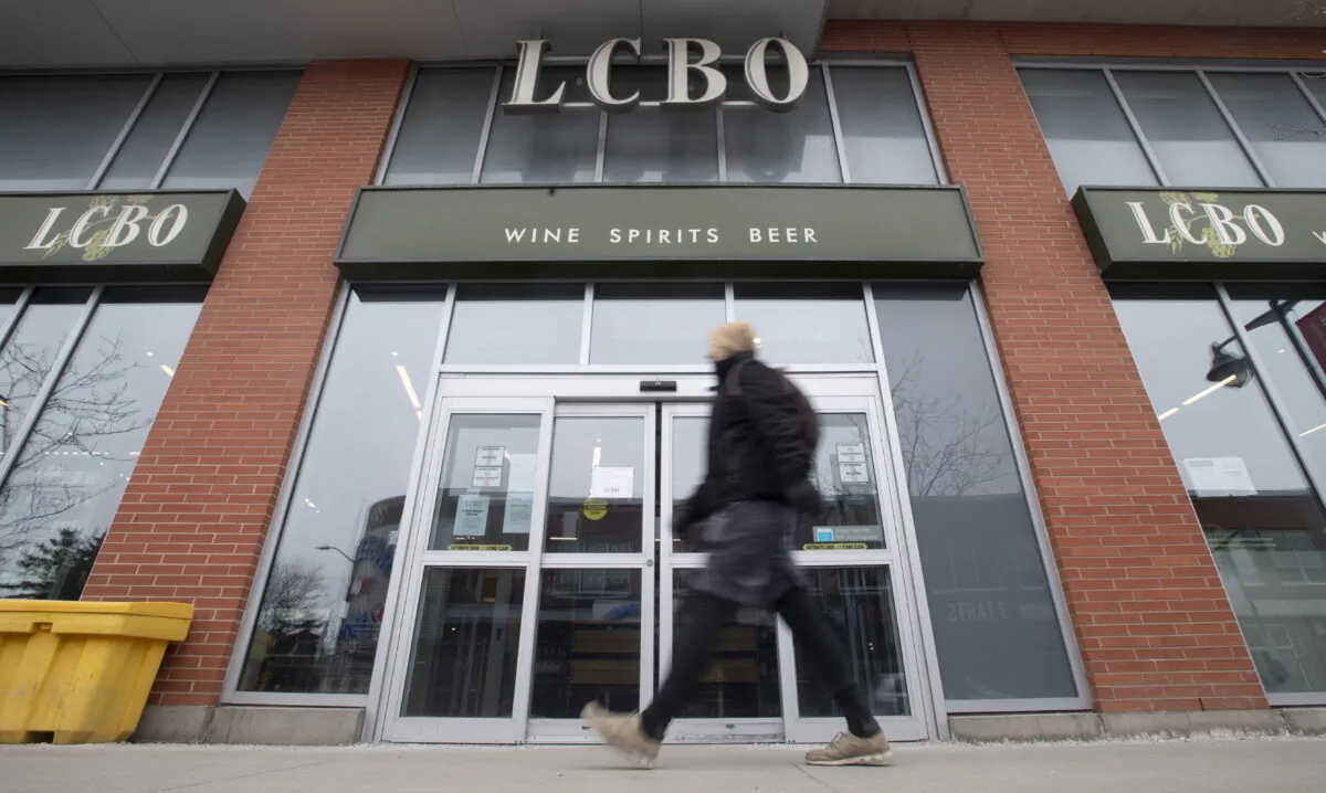 A person walks past an LCBO in Ottawa on March 19, 2020. (The Canadian Press/Adrian Wyld)