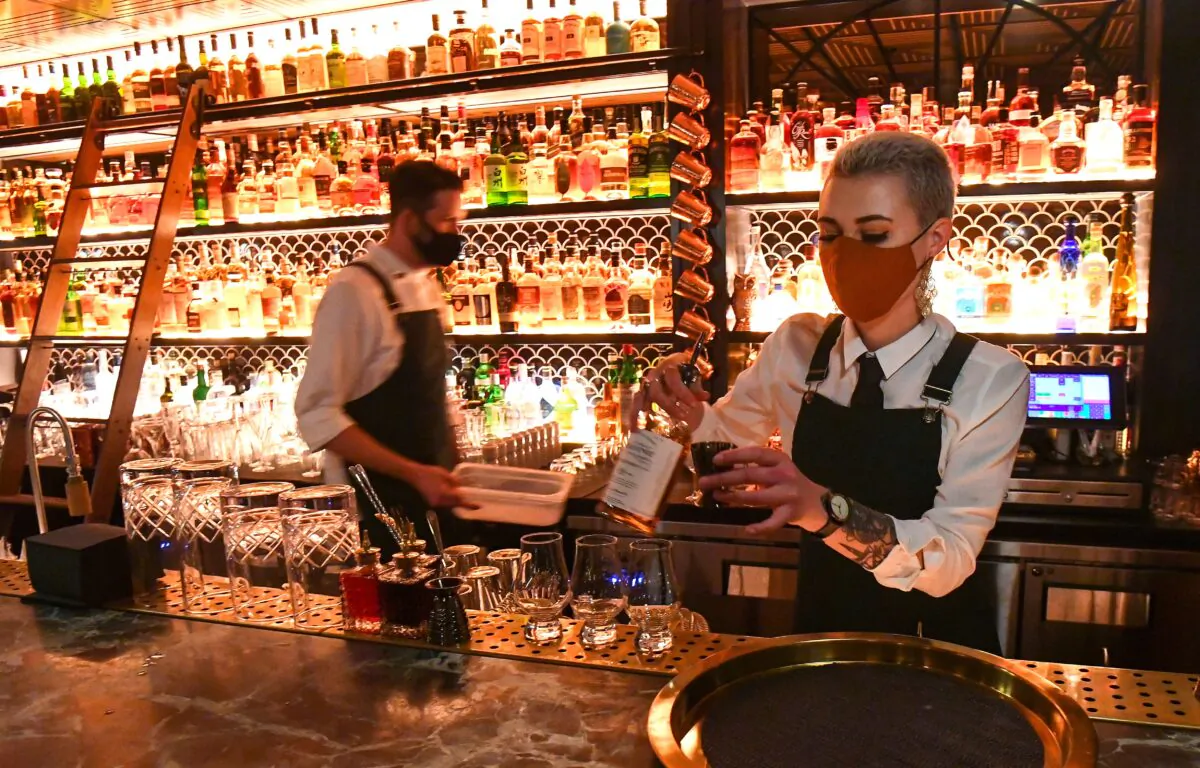 A bar staff prepares drinks for patrons in a bar in Melbourne, Australia, on Oct. 28, 2020. (William West/AFP via Getty Images)