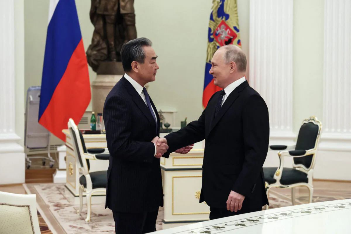 Russian President Vladimir Putin meets with China's Director of the Office of the Central Foreign Affairs Commission Wang Yi at the Kremlin in Moscow on Feb. 21, 2023. (Anton Novoderezhkin/Sputnik/AFP via Getty Images)
