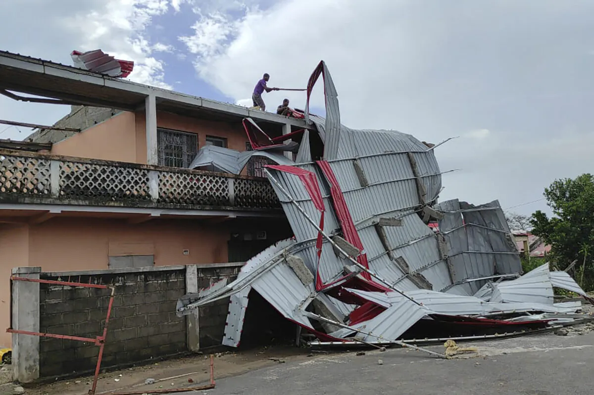 People work on a damaged building in Mananjary district, Madagascar, on Feb. 22, 2023, after cyclone Freddy reached Madagascar. (Solofo Rasolofomanana/AP Photo)