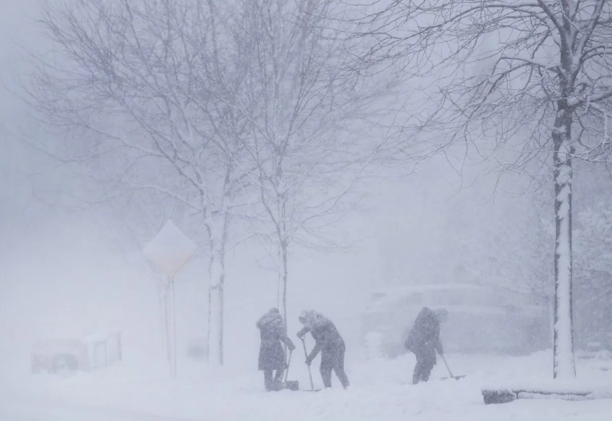 People shovel their driveways in a snow blizzard in Mississauga, Ont., on Jan. 25, 2023. (The Canadian Press/Nathan Denette)