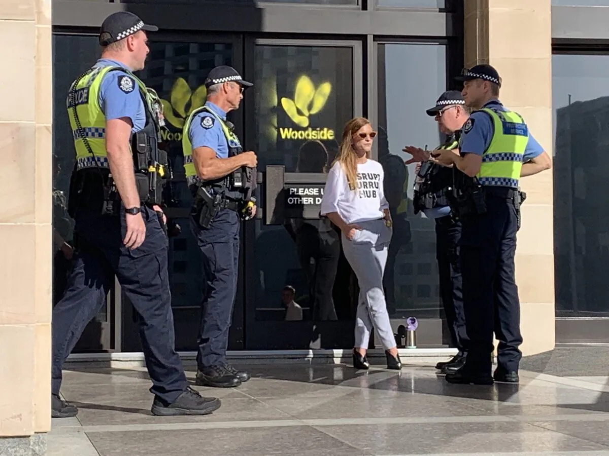 Police charged a protester with one count of criminal damage after she spray-painted the Woodside Energy logo on the front doors of the Western Australia parliament in Perth, Australia, on Feb. 22, 21. (Courtesy of Disrupt Burrup Hub)