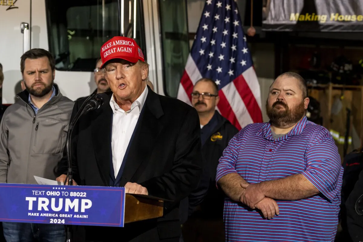 Former President Donald Trump stands next to a pallet of water before delivering remarks at the East Palestine Fire Department station in East Palestine, Ohio, on Feb. 22, 2023. (Michael Swensen/Getty Images)