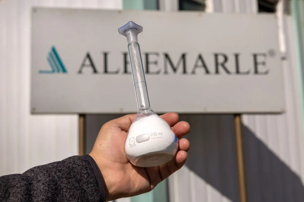 Albemarle Corporation spokesman Marcelo Valdebenito holds a bottle of processed lithium carbonate at a lithium mine in Salar de Atacama, Chile on Aug. 24, 2022. (John Moore/Getty Images)