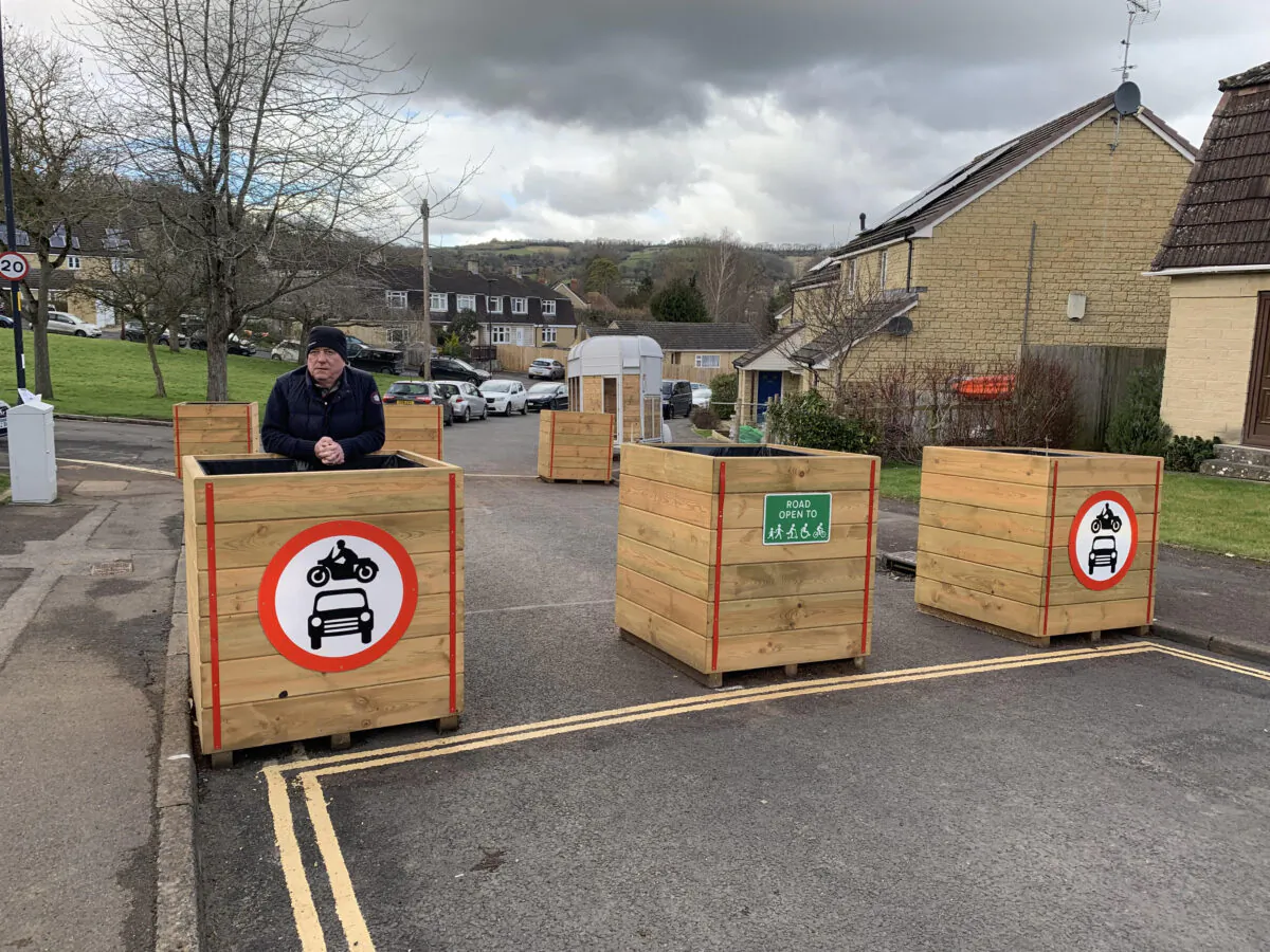 Graham Pristo is pictured standing next to LTN bollards in his area of Bath, England on Feb. 22, 2023. (Owen Evans/The Epoch Times)