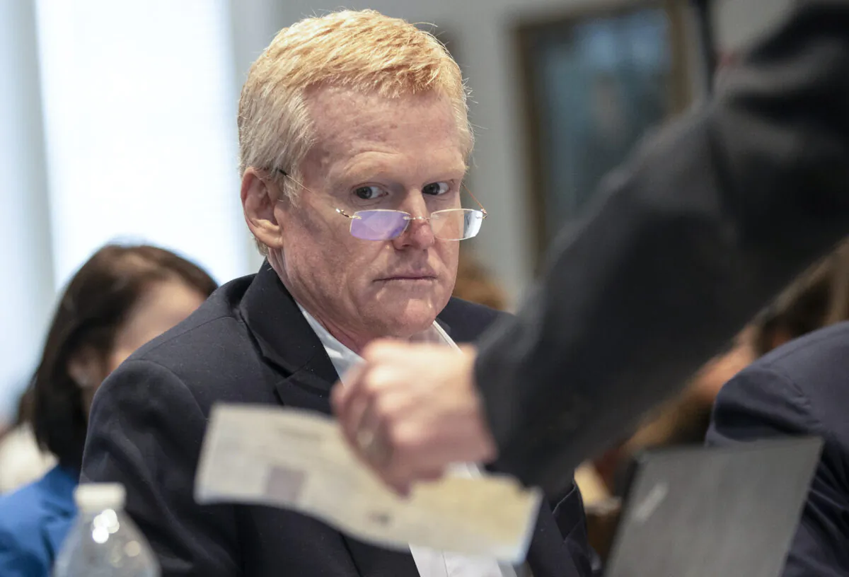Alex Murdaugh looks over evidence of a check brought to him and his attorneys during his double murder trial at the Colleton County Courthouse in Walterboro, S.C., on Feb. 7, 2023. (Andrew J. Whitaker/The Post And Courier via AP, Pool)
