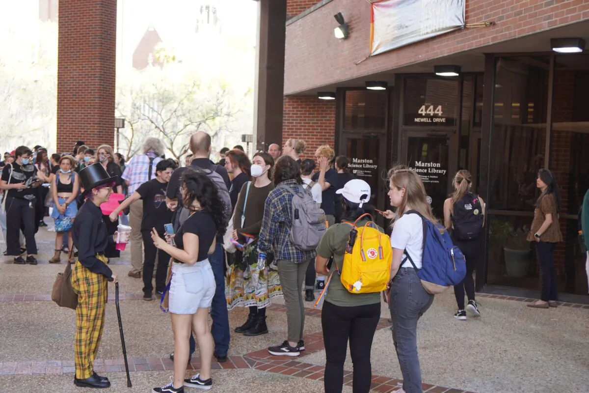 Some 100 students at the University of Florida gather at the Marston Science Library on the campus in Gainesville, Fla., on Feb. 23, 2023 as part of a planned "walkout" to protest against Republican Gov. Ron DeSantis's efforts to curb Diversity, Equity and Inclusion (DEI) programs in public universities and colleges around the state. (Nanette Holt/The Epoch Times)