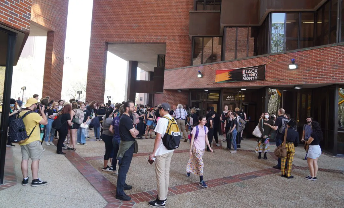 Students at the University of Florida gather at the Marston Science Library on the campus in Gainesville, Fla., on Feb. 23, 2023 as part of a planned "walkout" to protest against Republican Gov. Ron DeSantis's efforts to curb Diversity, Equity and Inclusion (DEI) programs in public universities and colleges around the state. (Nanette Holt/The Epoch Times)