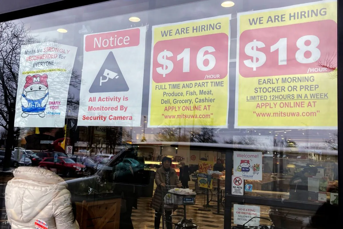 Hiring signs are displayed at a grocery store in Arlington Heights, Ill., on Jan. 13, 2023. (Nam Y. Huh/AP Photo)