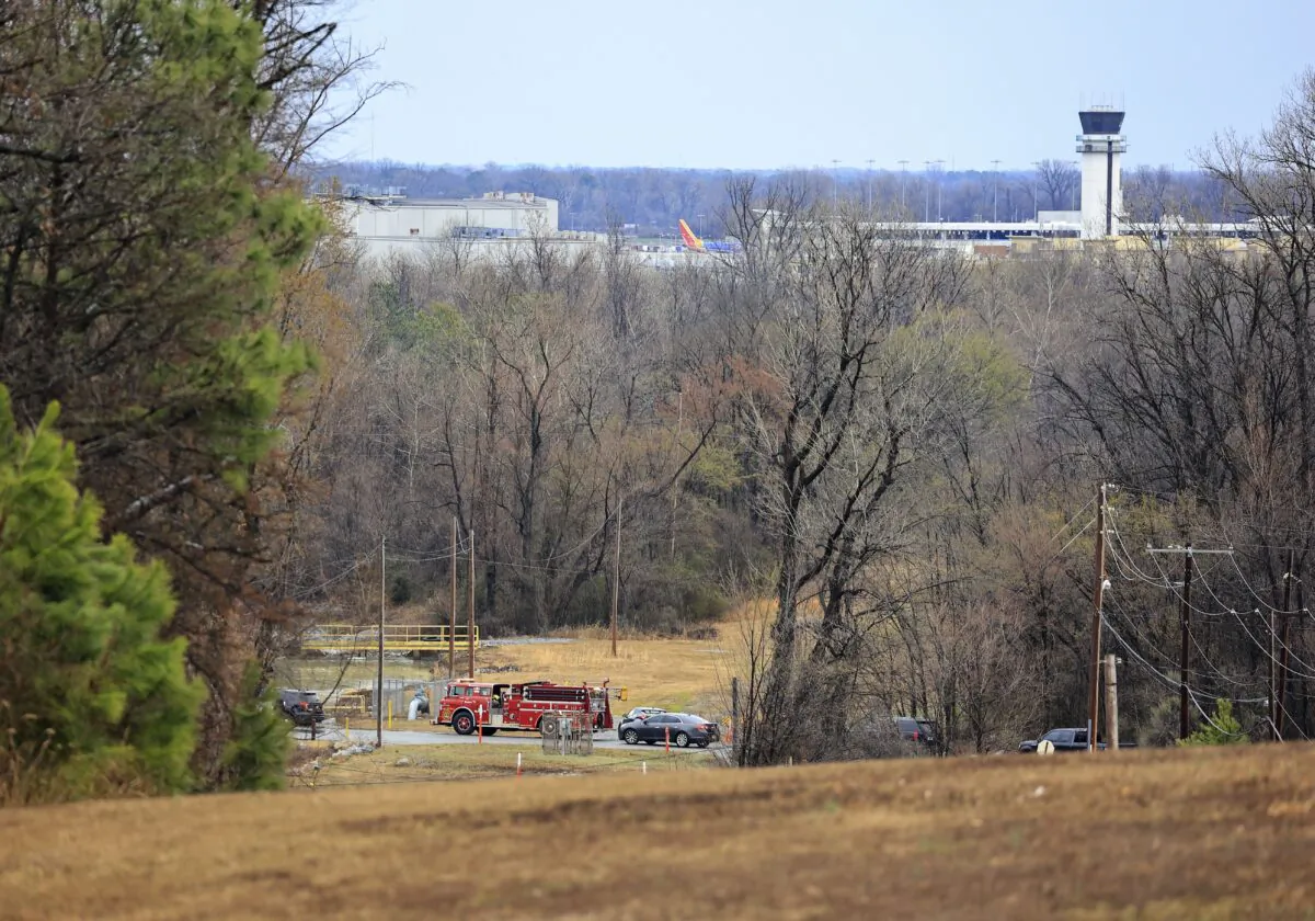 Emergency vehicles appear near the location where a small aircraft crashed while taking off from the Bill and Hillary Clinton National Airport in Little Rock, Ark., Wednesday Feb. 22, 2023. (Staton Breidenthal/Arkansas Democrat-Gazette via AP)