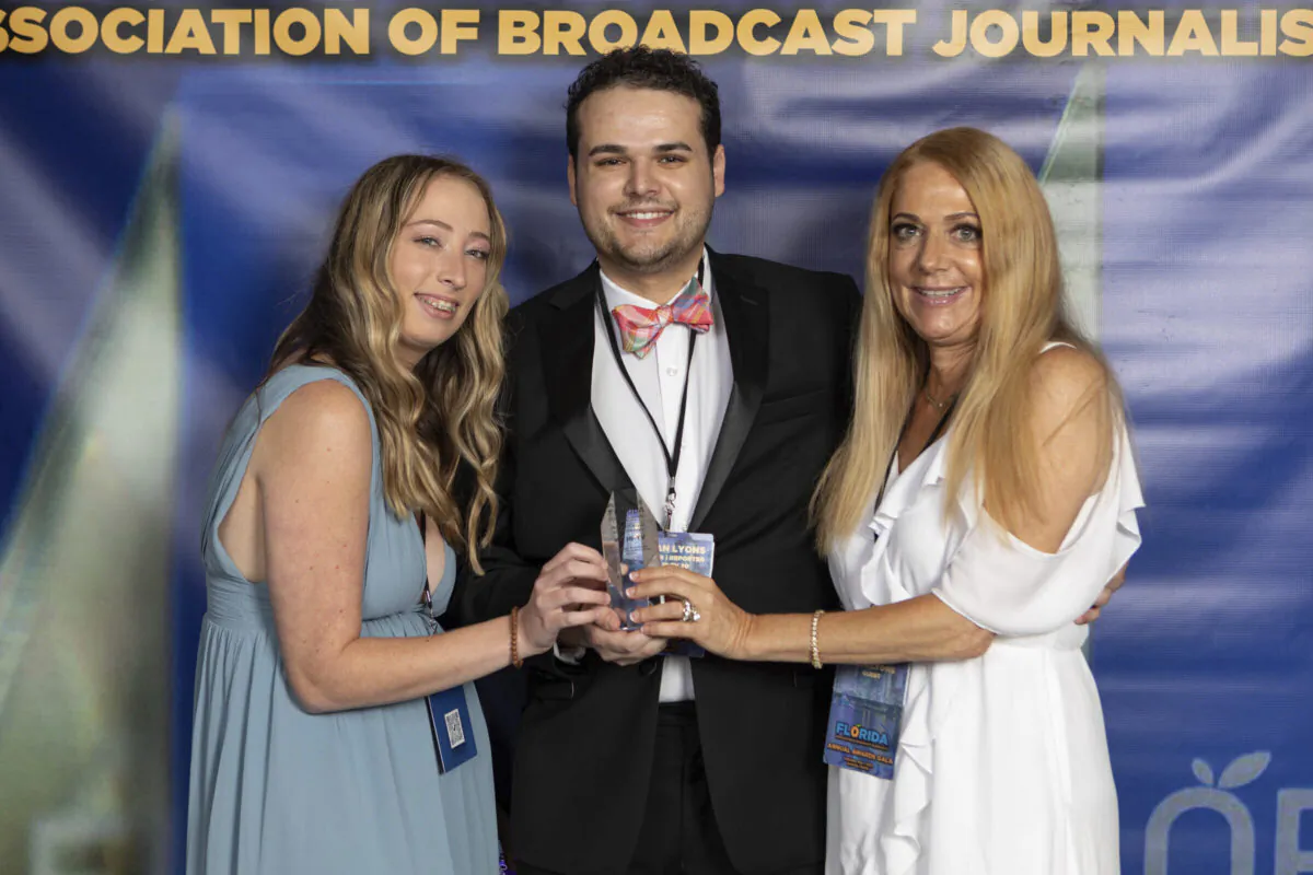TV journalist Dylan Lyons, 24, poses for a photo with his girlfriend (L) and mother at the Florida Association of Broadcast Journalists awards ceremony in Orlando, Fla., on May 7, 2022. (Jonathan Galed via AP)