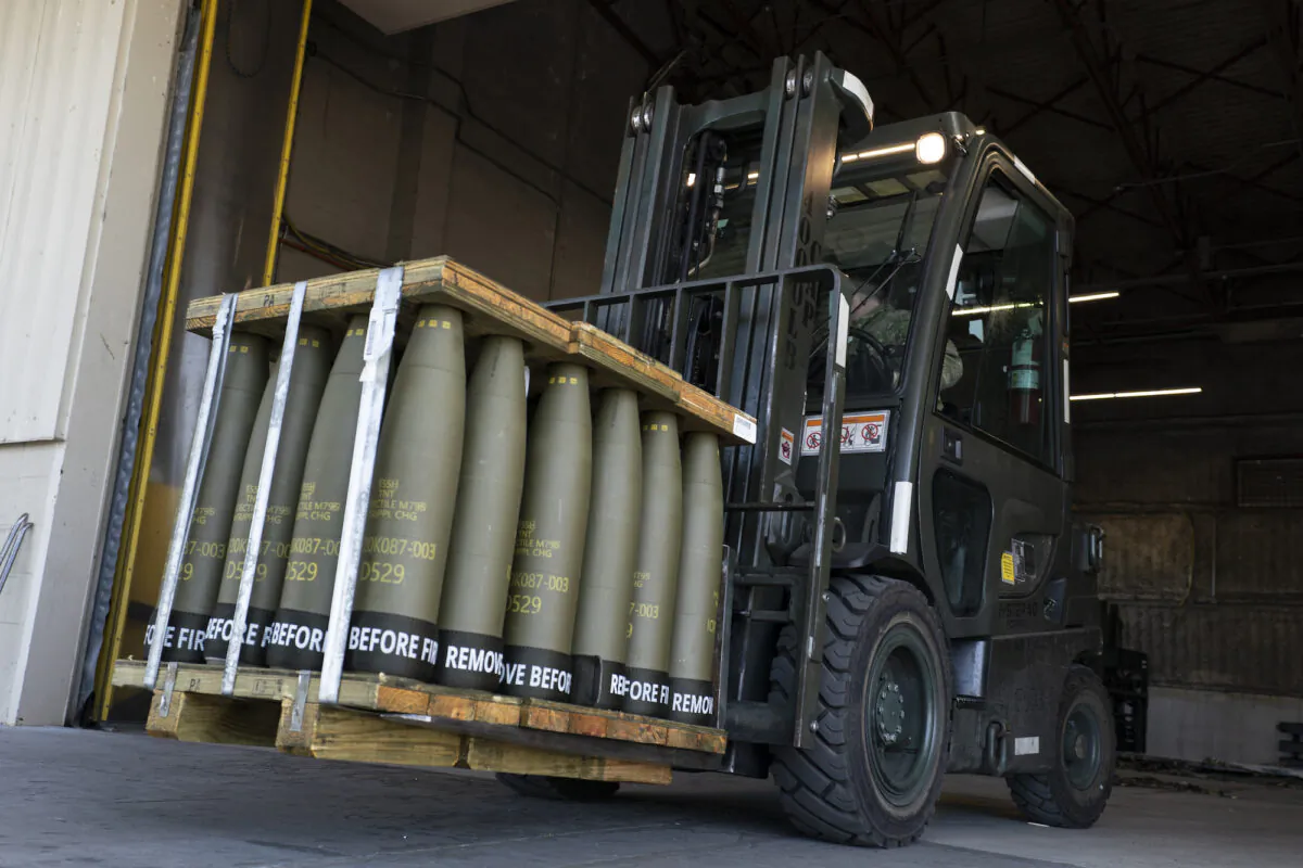 FILE - Airmen with the 436th Aerial Port Squadron use a forklift to move 155 mm shells ultimately bound for Ukraine, April 29, 2022, at Dover Air Force Base, Del. The Pentagon announced a new package of long-term security assistance for Ukraine on Friday, Feb. 24, 2023, marking the one-year anniversary of Russia's invasion with a $2 billion commitment to send more rounds of ammunition and a variety of small, high-tech drones into the fight. (AP Photo/Alex Brandon)