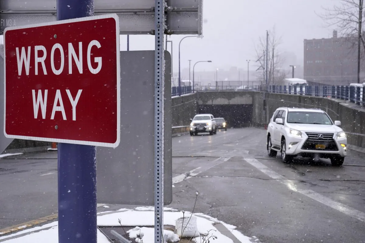 A "Wrong Way" sign warns drivers from entering westbound on an eastbound exit ramp from the Massachusetts Turnpike, Route I-90, in Boston on Feb. 23, 2023. (Steven Senne/AP Photo)