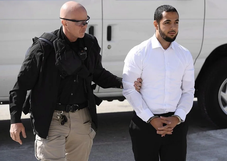Awso Peshdary, who is accused of recruiting for ISIL, is escorted by police as he arrives for a hearing at the Supreme Court of Canada in Ottawa on Aug. 13, 2018. (The Canadian Press/Justin Tang)