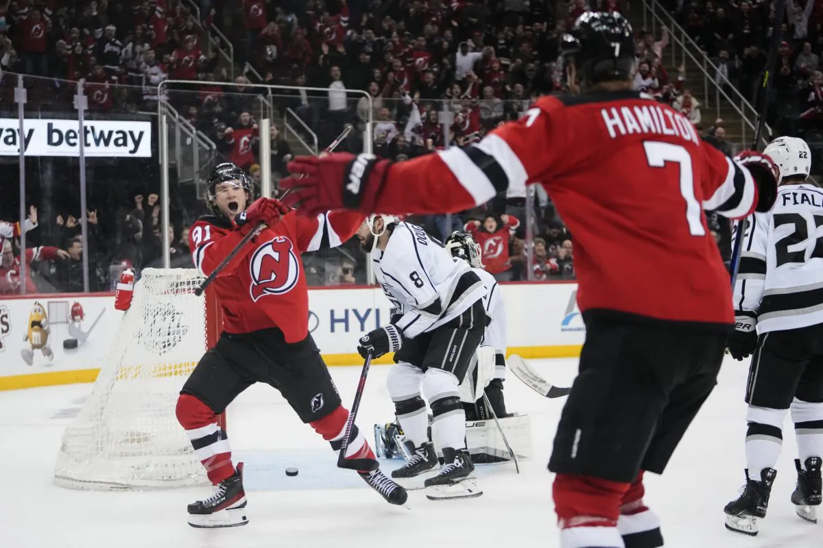 New Jersey Devils' Dawson Mercer (91) celebrates with teammate Dougie Hamilton (7) after scoring the game winning goal during the overtime period of an NHL hockey game against the Los Angeles Kings in Newark, N.J, on Feb. 23, 2023. (Frank Franklin II/AP Photo)
