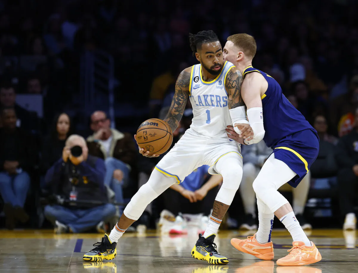 D'Angelo Russell (1) of the Los Angeles Lakers controls the ball against Donte DiVincenzo #0 of the Golden State Warriors in the first half in Los Angeles on Feb. 23, 2023. (Ronald Martinez/Getty Images)