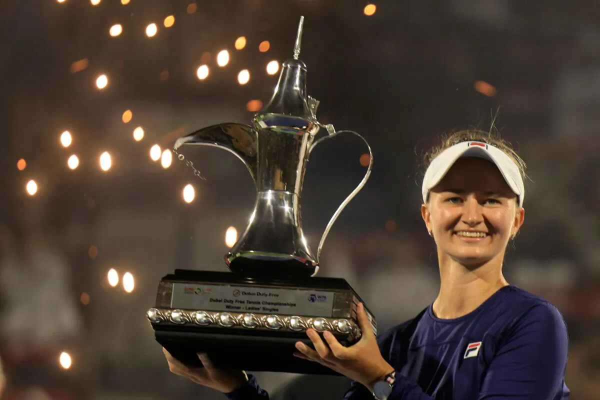 Barbora Krejcikova of the Czech Republic lifts the trophy of the WTA Dubai Duty Free Tennis Championship after defeating Iga Swiatek (not pictured) of Poland in the final match in Dubai on Feb. 25, 2023. (Karim Sahib/AFP via Getty Images)