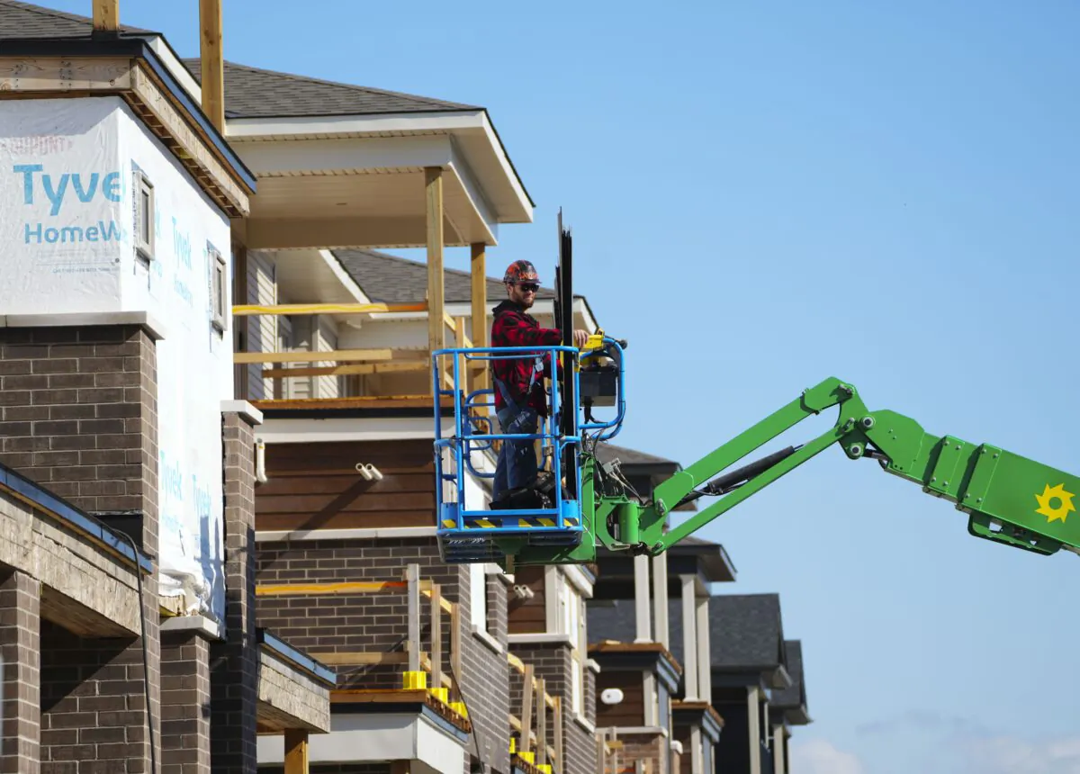 A construction worker works from a lift at a new housing development in Ottawa on Oct. 14, 2022. A new report from Statistics Canada indicates the economy flatlined in the last quarter of 2022. (The Canadian Press/Sean Kilpatrick)