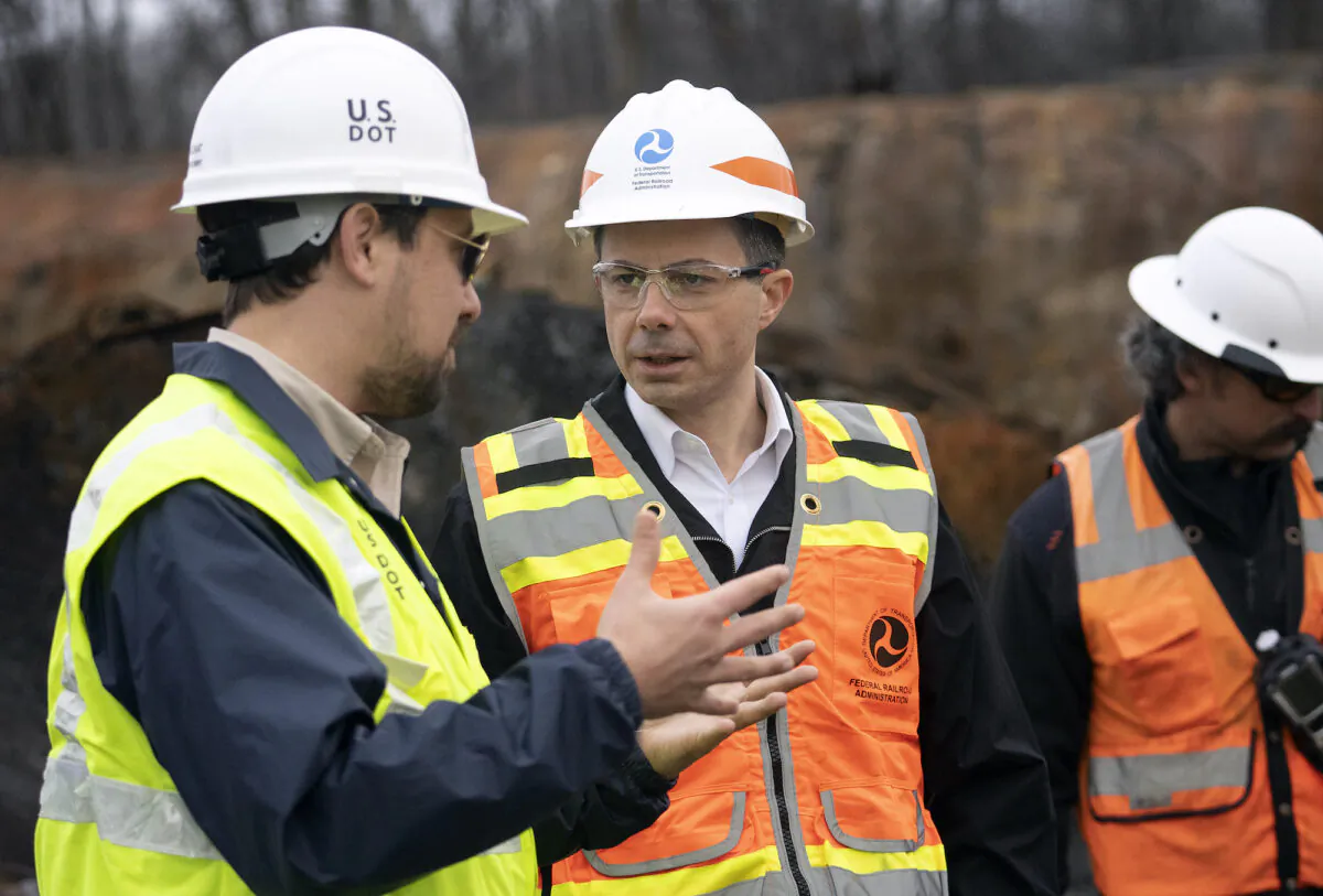 Secretary of Transportation Pete Buttigieg (C) visits with Department of Transportation investigators at the site of the derailment in East Palestine, Ohio, on Feb. 23 2023. (Brooke LaValley-Pool/Getty Images)
